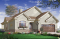 Vue avant - MODÈLE DE BASE - Maison de type plain-pied, garage double, 3 chambres, patio couvert, foyer, terrasse abritée latérale - Belita