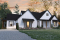 Vue avant - MODÈLE DE BASE - Plan de maison bi-génération de style Farmhouse Moderne, avec garage, superbe terrasse abritée - Génération